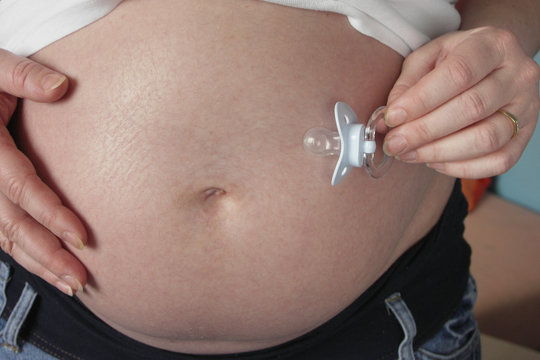 pregnant women with dummy near belly