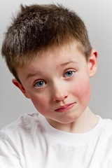 Sad little boy looking to camera