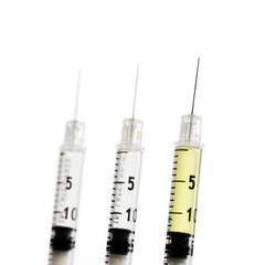 three syringes isolated on white