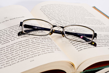 glasses on the open book 