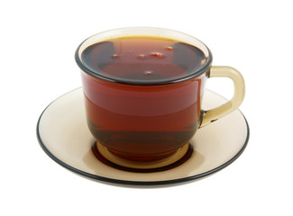 Glass cup of hot tea on plate isolated