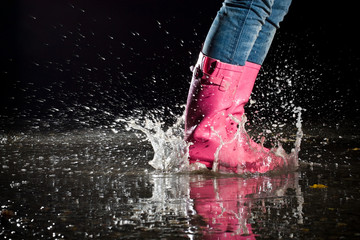 girl jumping in the puddle