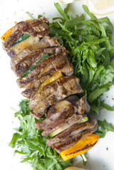 shashlik with potherbs on the plate