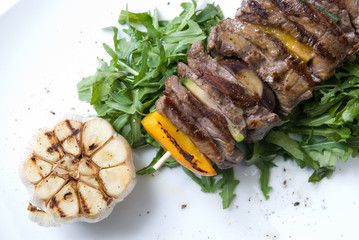 shashlik with potherbs on the plate