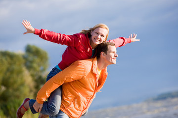 Young love Couple smiling under blue sky