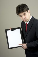 Business man in dark suit holding clipboard