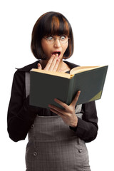 Fototapeta premium Surprised brunette schoolgirl looking in the book