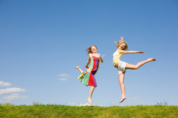 Two happy girls jumping