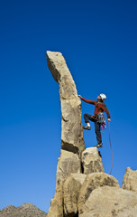 Rock climber nearing the summit.