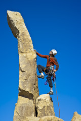 Rock climber nearing the summit.