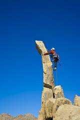 Rock climber nearing the summit.