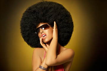 Beautiful woman with huge afro haircut on yellow - obrazy, fototapety, plakaty
