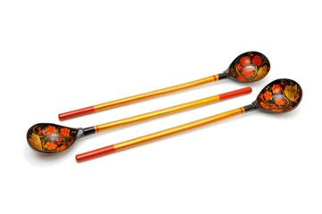 Three Russian wooden painted spoons with long handles isolated