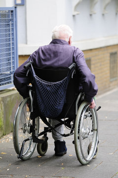old handicapped man using a mechanic wheelchair