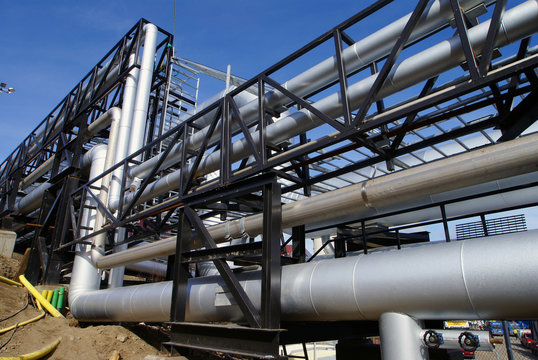 industrial pipelines on pipe-bridge against blue sky