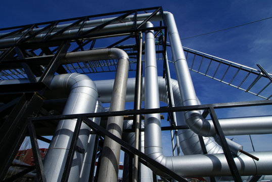 industrial pipelines on pipe-bridge against blue sky