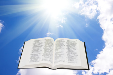 Holy bible in the sky illuminated by a sunlight