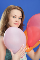 portrait of a girl holding color balloons