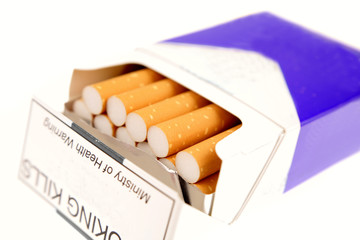 Open pack of cigarettes over white
