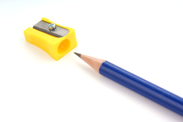 A blue pencil and knife-sharpener over white