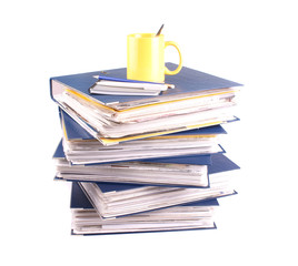 Stack of file folders, stationery and cup isolated