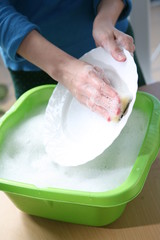 close-up of female hands washing dishes