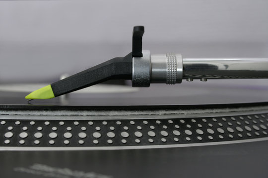 DJ turntable needle in close-up, sideview