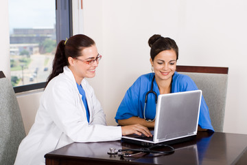 young female doctors sitting in front of a laptop computer