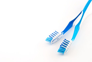 two toothbrushes on a white background