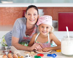 Mother and child in the Kitchen Smiling at Camera