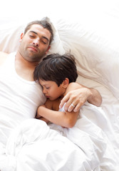 Obraz na płótnie Canvas Father and Son asleep on bed