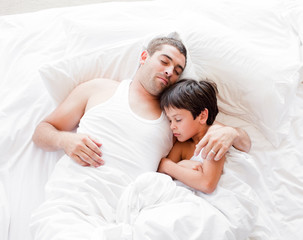 Obraz na płótnie Canvas Father and Son Lying on bed