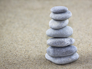 Fototapeta na wymiar Balancing pebbles placed on sand