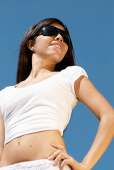 Portrait of cute young girl against sky