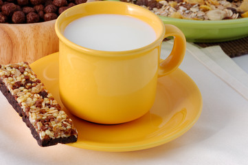 The cereal bar with cup of milk