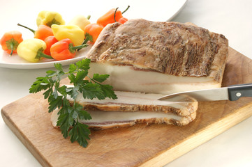 fetter Speck und Petersilie auf einem Holzbrett