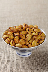 Roasted salted pistachios in an elegant bowl,