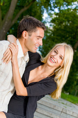 Young happy attractive embracing couple, outdoors