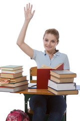 Caucasian schoolgirl with raised hand in class