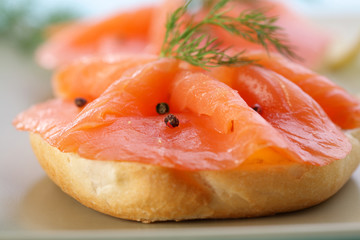 Smoke salmon on bagel with freshly black pepper.