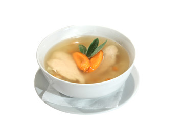 chicken soup with carrots and sage in bowl