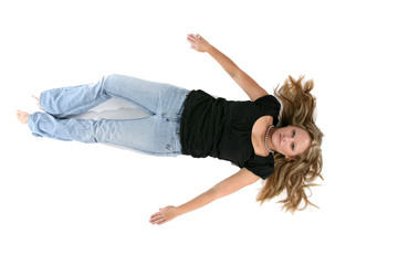 young woman on her back on the floor with arms out