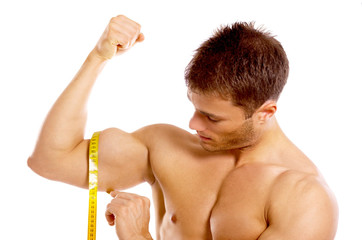 Muscular and tanned man is being measured