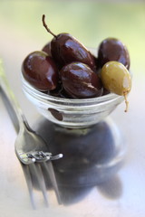 One Green Olive with Black Olives