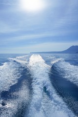 Boat white wake on the blue ocean sea