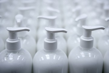White plastic soap bottles in rows assembly line © lunamarina