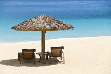 Beach Chairs and Umbrella on a Tropical Beach