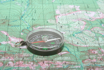 Fototapeta na wymiar compass on topographical map