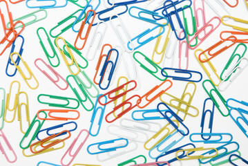Colored paper clips on white background