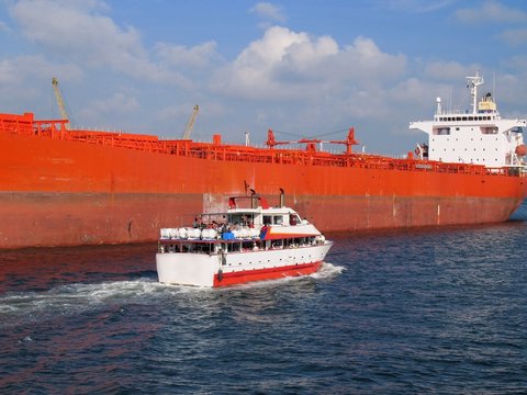 Two Ships in Contrast -- Supertanker and Tourist Boat